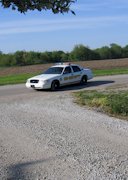 Sexy Melissa posing nude in a cop car